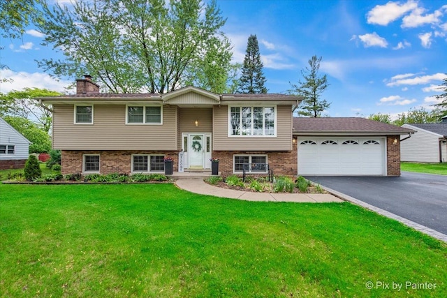 537 71st St, Darien, IL 60561 - raised ranch featuring brick siding, a chimney, driveway, a garage, and a front lawn