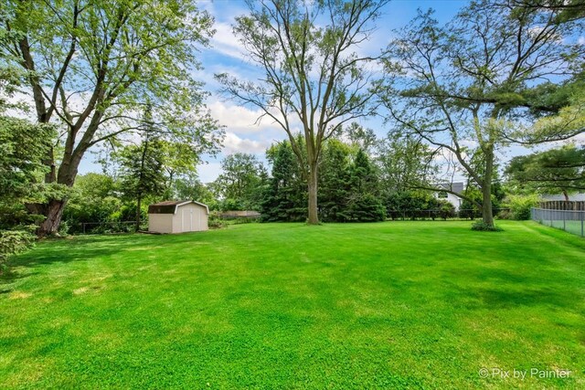537 71st St, Darien, IL 60561 - fenced backyard featuring a storage shed