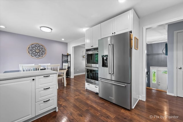537 71st St, Darien, IL 60561 - kitchen featuring stainless steel appliances, dark wood-style flooring, recessed lighting, white cabinetry, and light countertops