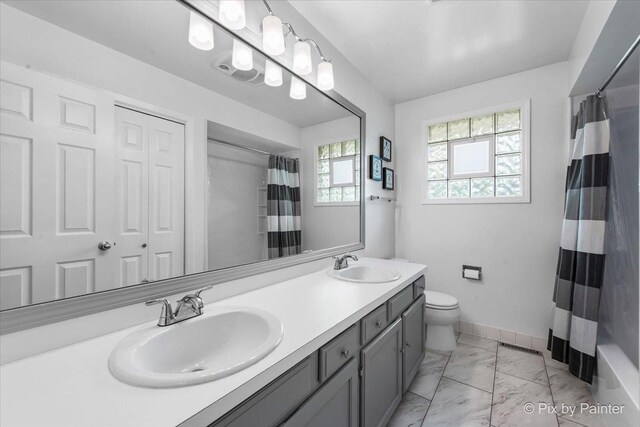 537 71st St, Darien, IL 60561 - bathroom with marble look tiles and double vanity