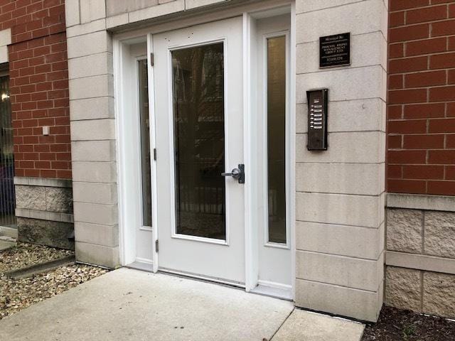 property entrance featuring brick siding