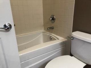 full bathroom featuring shower / bathing tub combination and toilet