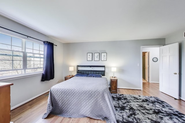 bedroom with baseboards and wood finished floors