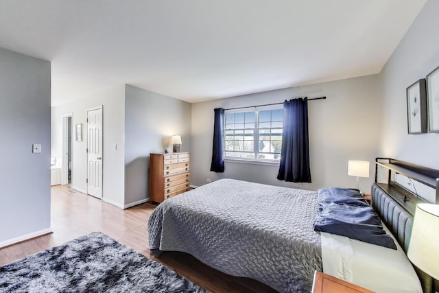bedroom featuring baseboards and wood finished floors