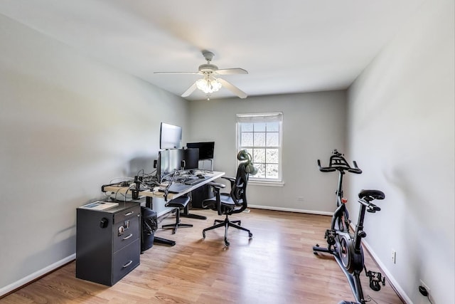 office area featuring baseboards, light wood-style floors, and ceiling fan