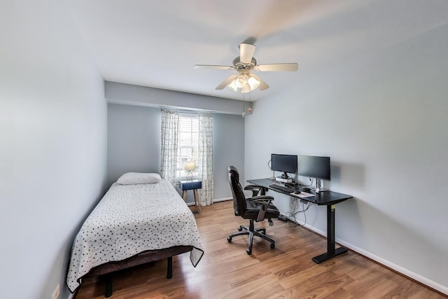 home office with baseboards, a ceiling fan, and wood finished floors