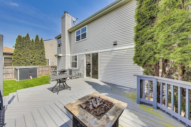 deck with fence and a fire pit
