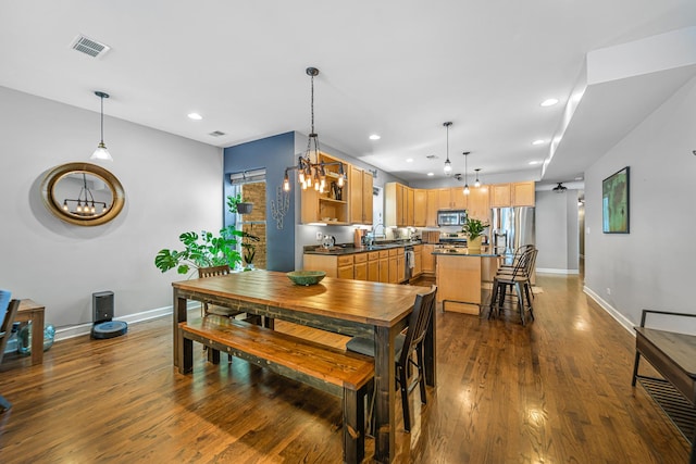 5016 N Sheridan Rd Unit 1, Chicago, IL 60640 - dining room with a chandelier, baseboards, visible vents, and dark wood-style floors