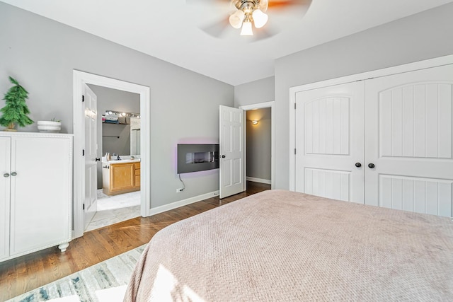 5016 N Sheridan Rd Unit 1, Chicago, IL 60640 - bedroom with wood finished floors, a ceiling fan, a closet, ensuite bathroom, and baseboards