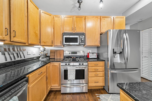 5016 N Sheridan Rd Unit 1, Chicago, IL 60640 - kitchen featuring dark stone counters, appliances with stainless steel finishes, and dark wood-style flooring