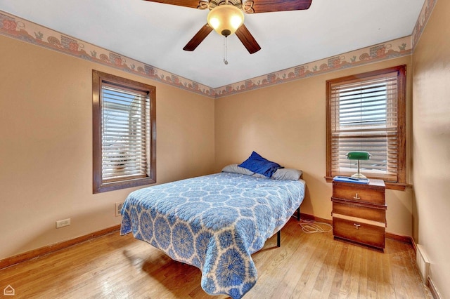bedroom featuring visible vents, hardwood / wood-style floors, and baseboards