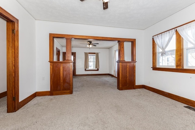 carpeted empty room featuring ceiling fan, baseboards, and visible vents