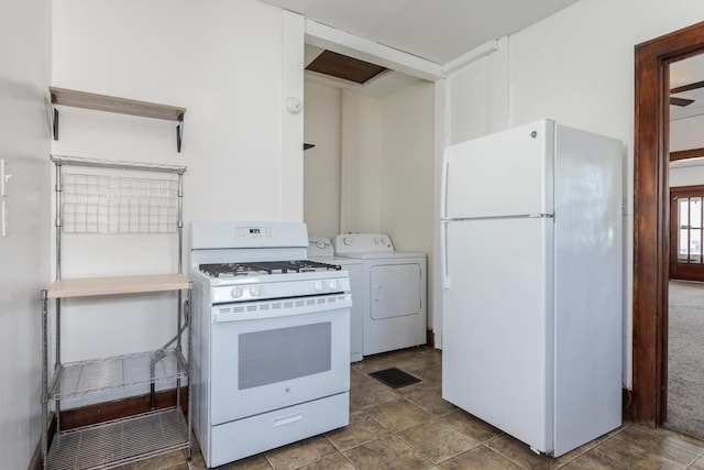 kitchen with light countertops, washer and clothes dryer, visible vents, and white appliances