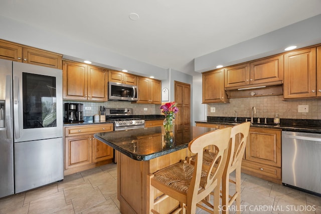 2288 Westminster St, Wheaton, IL 60189 - kitchen featuring appliances with stainless steel finishes, a breakfast bar, a center island, and backsplash