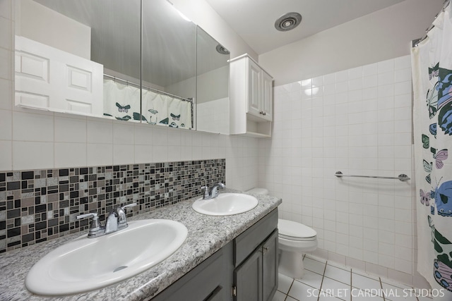2288 Westminster St, Wheaton, IL 60189 - full bath featuring toilet, tile patterned floors, tile walls, and a sink