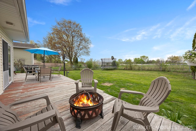 2288 Westminster St, Wheaton, IL 60189 - deck with outdoor dining area, a fenced backyard, a trampoline, an outdoor fire pit, and a yard