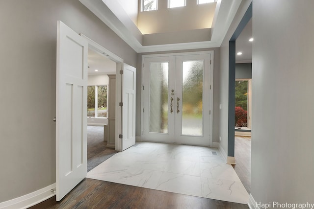foyer with recessed lighting, marble finish floor, baseboards, and french doors