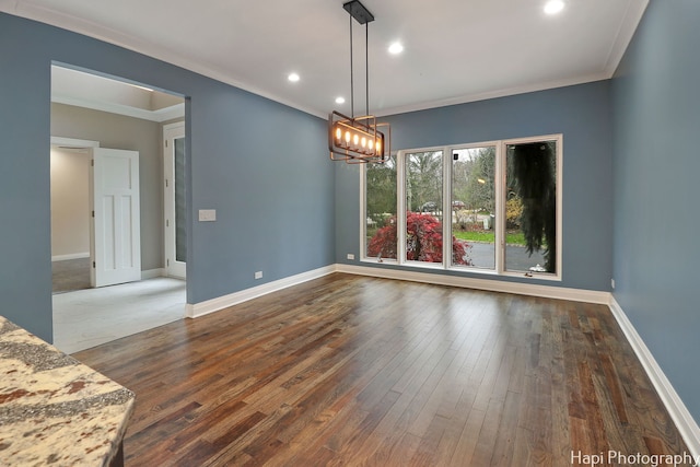 unfurnished dining area featuring a chandelier, recessed lighting, hardwood / wood-style floors, and ornamental molding