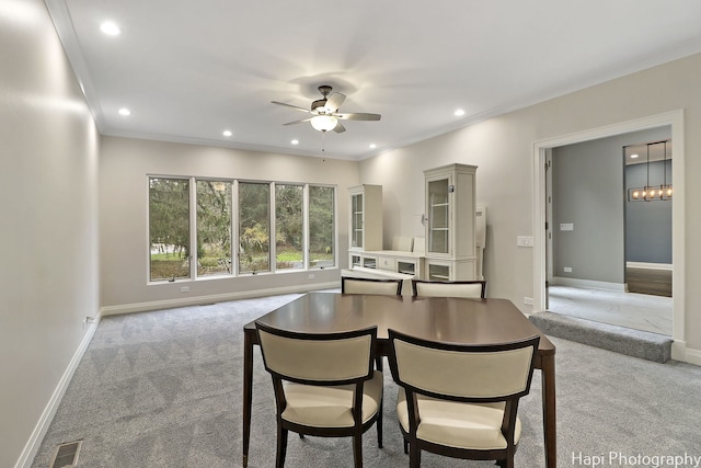 carpeted dining area featuring ornamental molding, visible vents, recessed lighting, and ceiling fan