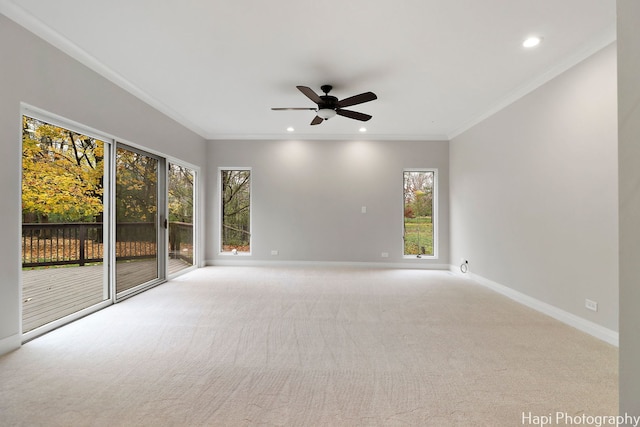 carpeted empty room with recessed lighting, crown molding, a ceiling fan, and baseboards