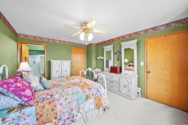 carpeted bedroom featuring a ceiling fan and connected bathroom
