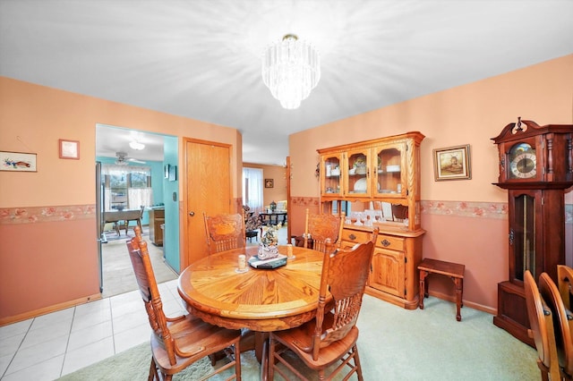 dining area with ceiling fan with notable chandelier