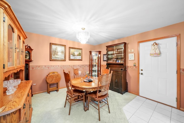 dining room with a chandelier and wainscoting