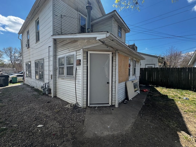 back of house featuring fence