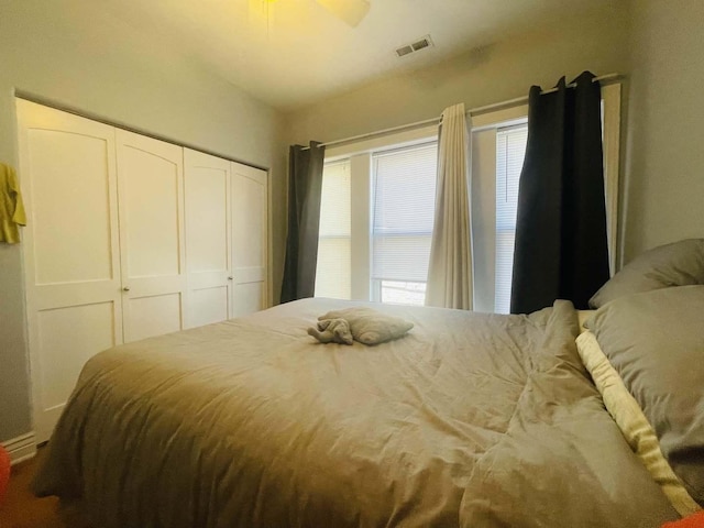 bedroom featuring a closet, visible vents, and ceiling fan