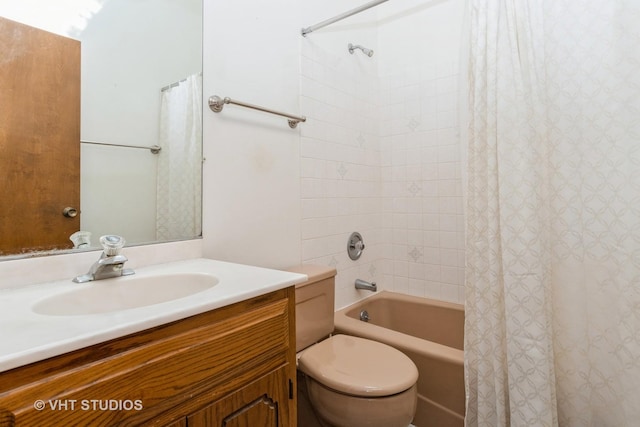 bathroom with shower / bathtub combination with curtain, vanity, and toilet