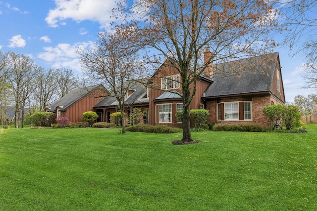 1135 Buttonwood Ln, Northbrook, IL 60062 - view of front facade featuring a chimney, a front yard, brick siding, and roof with shingles