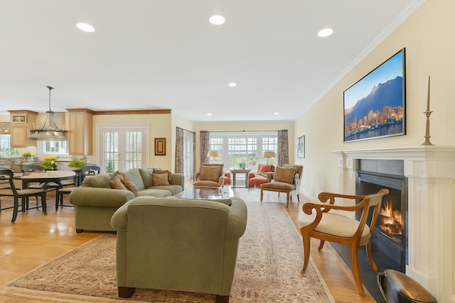 1135 Buttonwood Ln, Northbrook, IL 60062 - living room featuring a warm lit fireplace, light wood-type flooring, ornamental molding, recessed lighting, and baseboards