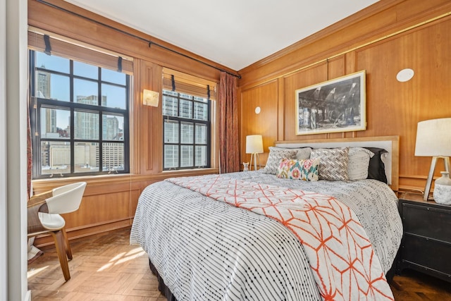bedroom featuring wooden walls