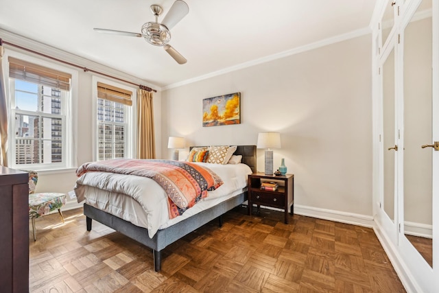 bedroom with baseboards, ornamental molding, and ceiling fan