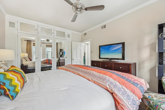 bedroom featuring ceiling fan, ornamental molding, and visible vents