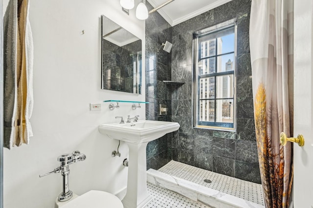 bathroom with ornamental molding and a tile shower