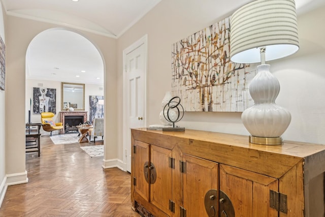 bar with baseboards, a fireplace, and arched walkways