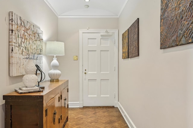 doorway to outside with ornamental molding and baseboards
