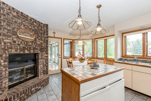7834 W Foresthill Ct Unit 1Cr, Palos Heights, IL 60463 - kitchen with tile counters, a sink, light tile patterned floors, and white cabinets