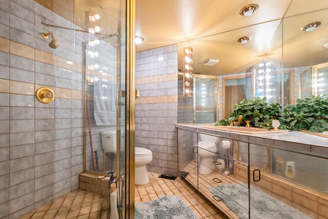 7834 W Foresthill Ct Unit 1Cr, Palos Heights, IL 60463 - bathroom with tile walls, tile patterned flooring, toilet, a stall shower, and vanity