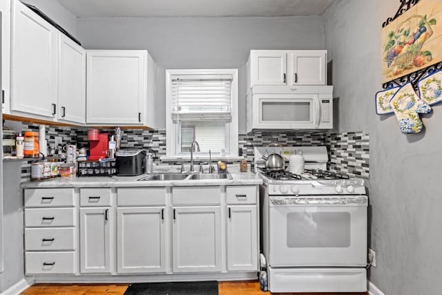 135 N Calhoun St, Aurora, IL 60505 - kitchen featuring white appliances, a sink, backsplash, white cabinetry, and light countertops