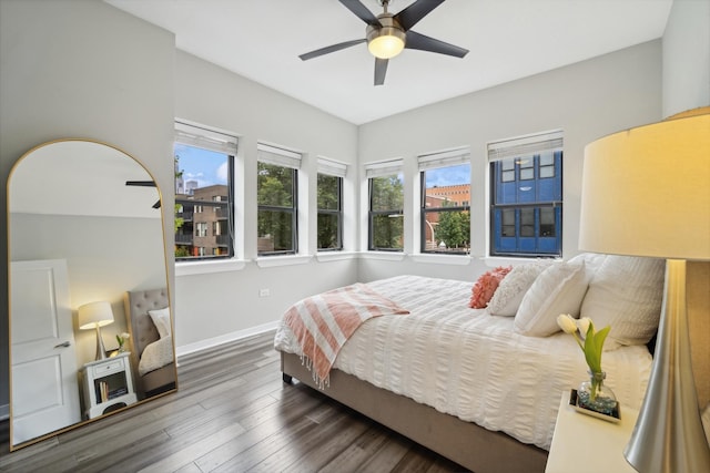 bedroom with baseboards, a ceiling fan, and wood finished floors