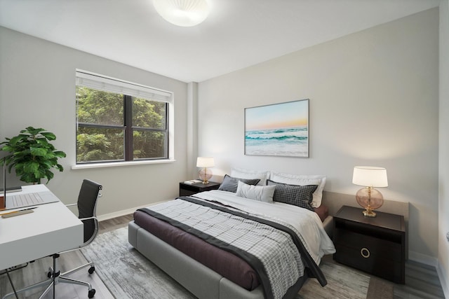 bedroom featuring baseboards and wood finished floors