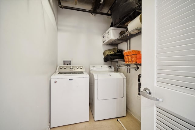 laundry room with separate washer and dryer, laundry area, and baseboards