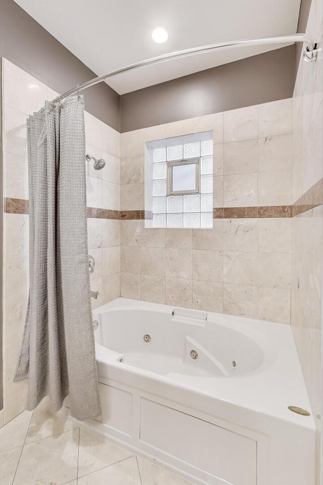 bathroom with tile patterned floors and a combined bath / shower with jetted tub