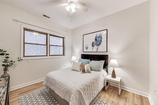 bedroom with baseboards, visible vents, ceiling fan, and light wood-type flooring