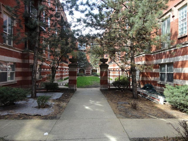 view of home's community with a gate and fence