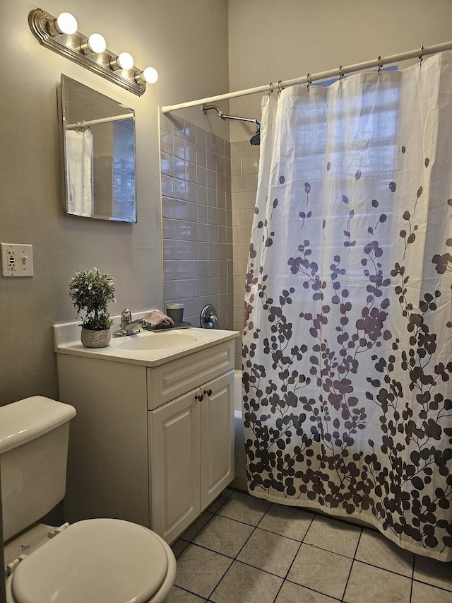 full bath featuring shower / tub combo, tile patterned floors, vanity, and toilet