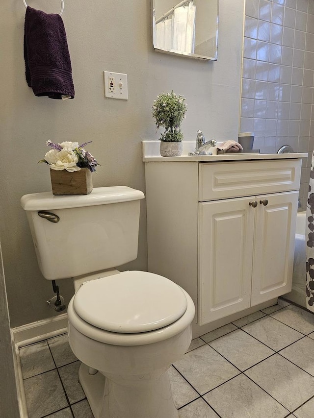 bathroom featuring vanity, a shower with curtain, baseboards, toilet, and tile patterned flooring