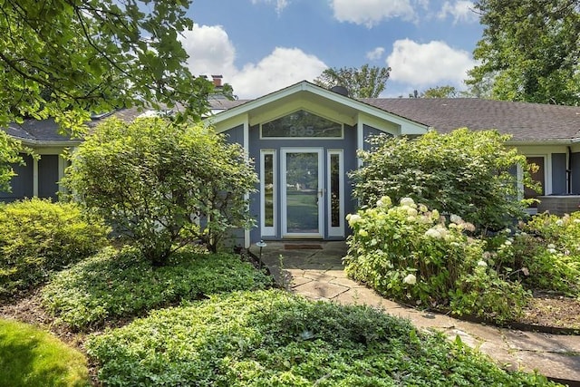 doorway to property with a chimney and stucco siding